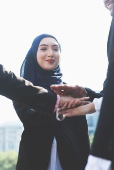 Multiracial business people stacking hands, businessman and businesswoman teamwork concept.