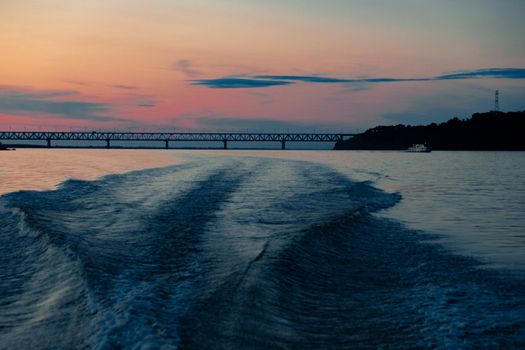 Splashes of water from the boat at sunset