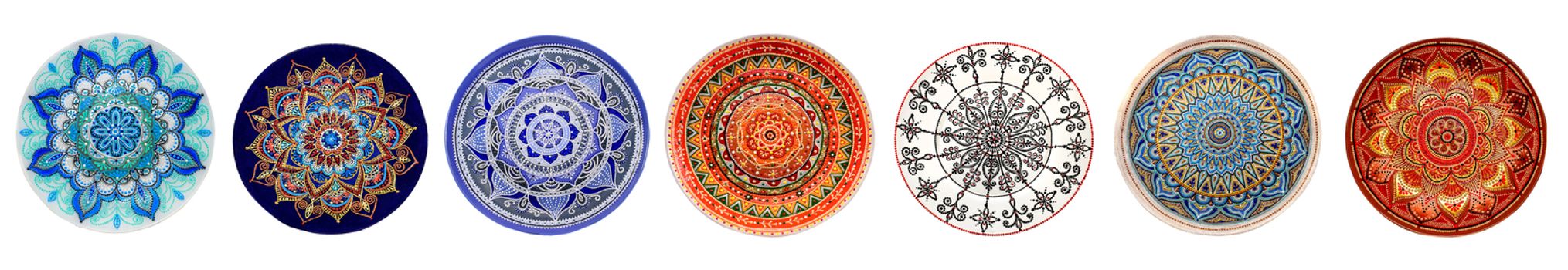 Set of decorative ceramic dishes hand-painted with acrylic paints floral pattern isolated on white background.