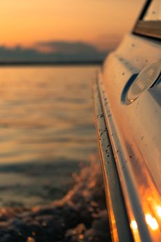 Splashes of water from the boat at sunset