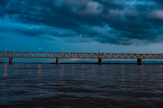 Bridge over the Amur river at sunset. Russia. Khabarovsk. Photo from the middle of the river