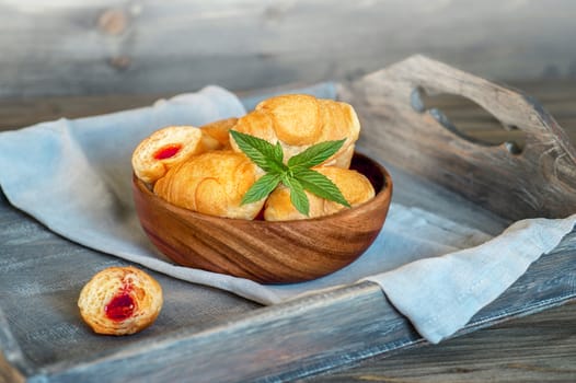 Croissants on a wooden tray. The concept of a wholesome breakfast