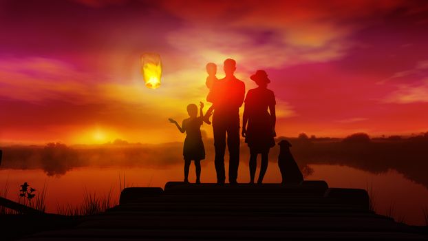Family silhouettes standing against a red sunset and launching a Chinese lantern.