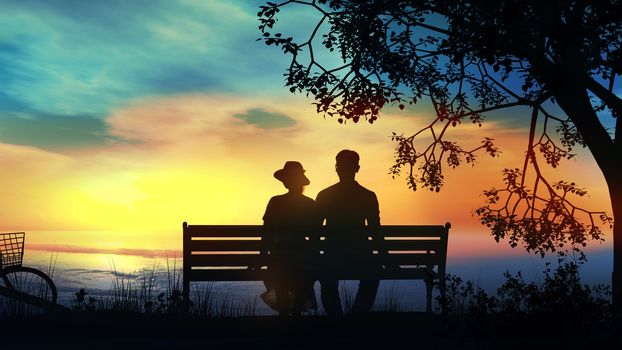 Silhouettes of a couple sitting on a bench and watching the ocean sunset.
