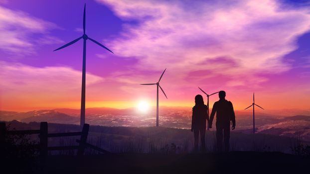Silhouettes of a couple of tourists on the background of wind power plants at sunset.