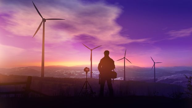 Silhouettes of wind turbines and the photographer with a tripod against the background of the sunset sky.