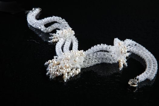 Different jewelries on a glass studio background