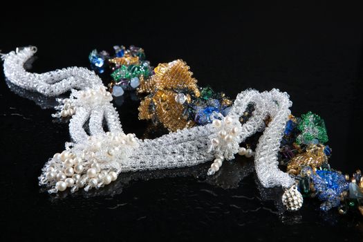 Different jewelries on a glass studio background