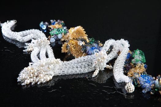 Different jewelries on a glass studio background