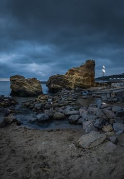 Dark and gloomy clouds asperatus over the sea until dawn.