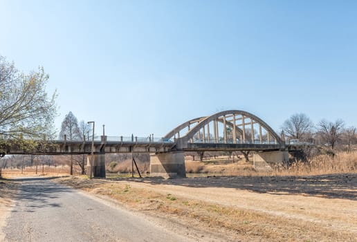 A street scene, with the Sarel Cilliers Bridge over the Vals River, in Kroonstad, a town in the Free State Province of South Africa