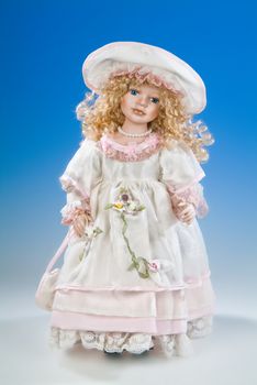 Big doll dressed in retro style on a blue and white background