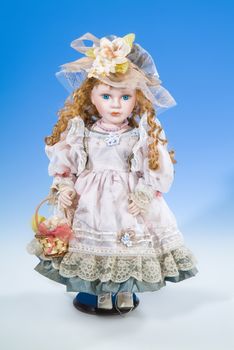 Big doll dressed in retro style on a blue and white background