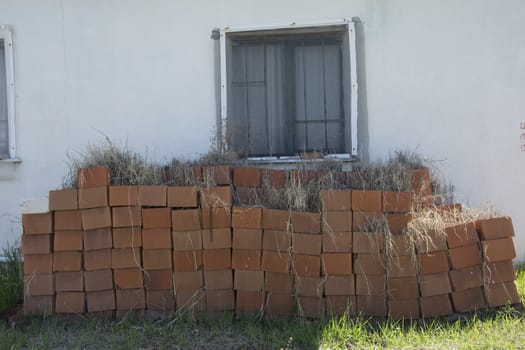 Heap brick. Because it is not used, there are weeds on it