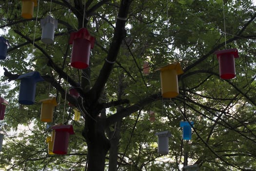 Adorned street trees. There are decorative balls, balloons, lamps and oil lamp