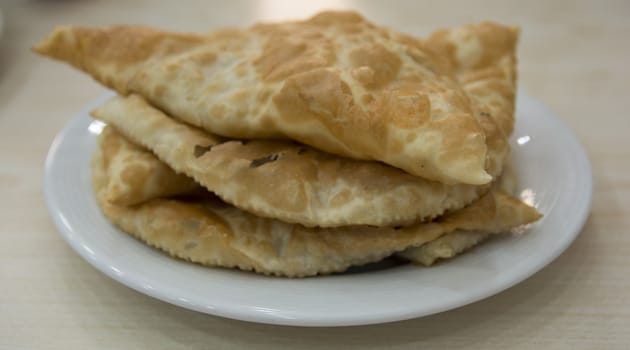 A mixture of minced meat, onion and spice is put in the opened yufkay and fried in oil. Crimean Tatar food.