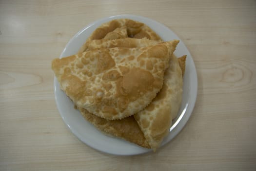 A mixture of minced meat, onion and spice is put in the opened yufkay and fried in oil. Crimean Tatar food.