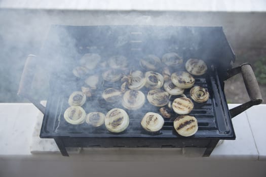 Barbecued onions and meat are cooked. Smoky and sooty