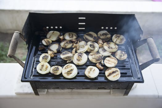 Barbecued onions and meat are cooked. Smoky and sooty