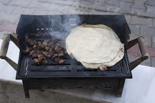 Barbecued onions and meat are cooked. Smoky and sooty