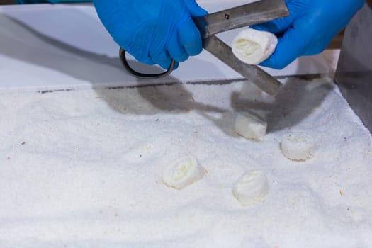 Turkish delight cutting.cut with special scissors. covered with coconut