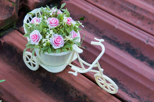 ornament for home. plastic toy bicycle decorating with flowers