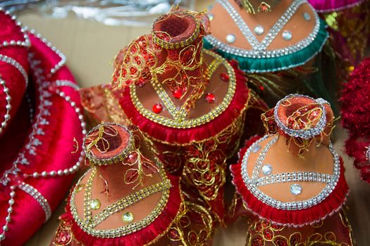 dowry ornament. decorated with stones and lace, colorful, shiny cover