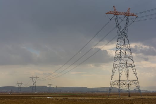 high voltage line passing through the field. electric wires