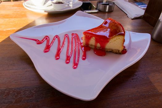 Strawberry cheesecake. a strawberry cream cake with strawberry sauce served on a nice plate