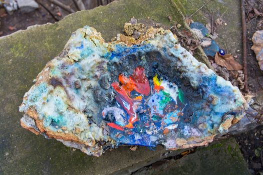 oven melting furnace used in making evil eye beads. over time the remaining residues from the beads stick to the oven pan. a colored mold is formed