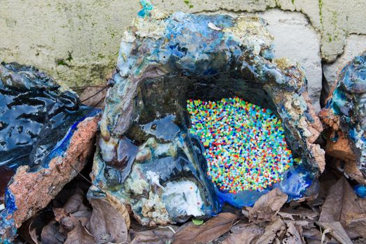 oven melting furnace used in making evil eye beads. over time the remaining residues from the beads stick to the oven pan. a colored mold is formed