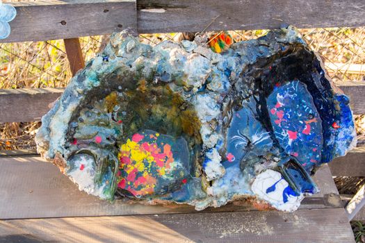 oven melting furnace used in making evil eye beads. over time the remaining residues from the beads stick to the oven pan. a colored mold is formed