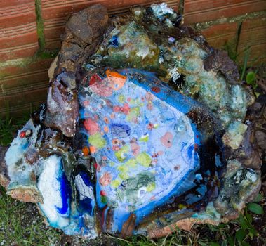 oven melting furnace used in making evil eye beads. over time the remaining residues from the beads stick to the oven pan. a colored mold is formed