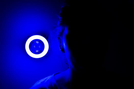 Lamp night light in a dark background. Vintage effect style picture. ring lamp. Neon light circle. the light takes the shape of a circle.the woman hiding in the dark. a symbol of violence for women