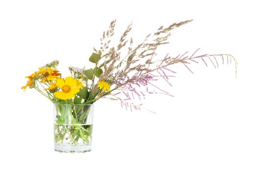 Bouquet of different wildflowers in a glass beaker, isolated on a white background