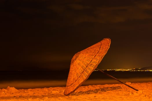 Night at the beach, falling umbrella