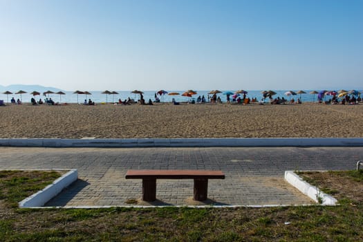 an empty seat on the crowded beach