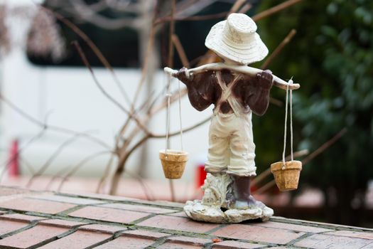 carrying water children's sculpture. garden trinket