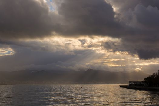 the sun shines through the clouds. sunlight reflected on the sea