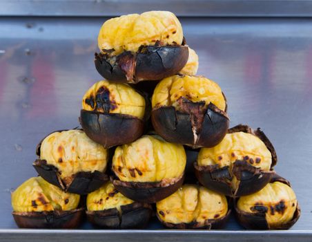 Grilled chestnuts for sale on street.cooked on barbecue. plenty of Christmas and winter are consumed
