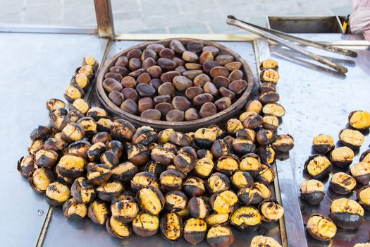 Grilled chestnuts for sale on street.cooked on barbecue. plenty of Christmas and winter are consumed