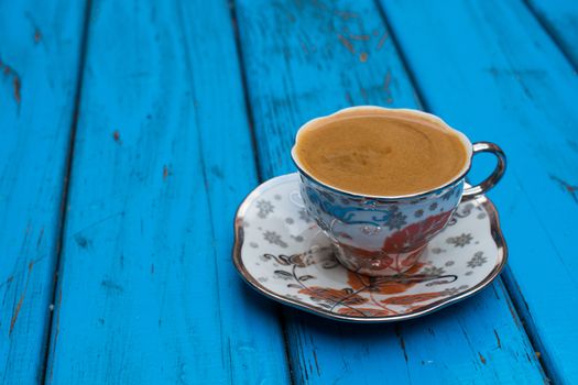 plenty of sparkling turkish coffee enjoyment. isolated blue background. side view. Free space for your text