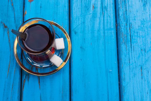 Black Turkish tea. Turkish national drink. well-brewed tea; It is called rabbit blood. isolated blue background. Top view. Free space for your text