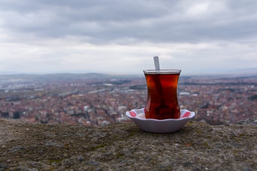 tea enjoyment. enjoying a hot tea while watching the city view from the top