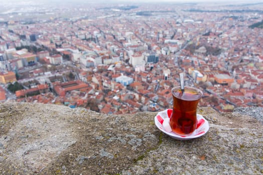 tea enjoyment. enjoying a hot tea while watching the city view from the top