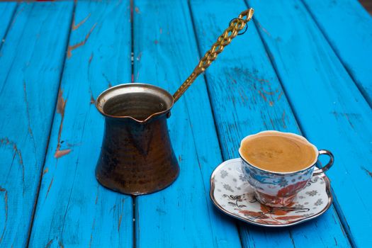 plenty of sparkling turkish coffee enjoyment. isolated blue background. side view. Free space for your text