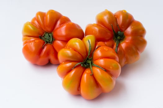 heirloom tomatoes. Fresh organic ripe tomatoes. red and green colored, sliced village tomato