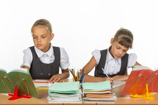 Two schoolgirls at a lesson at the same desk