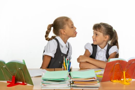 Girl at her desk showed tongue to another girl