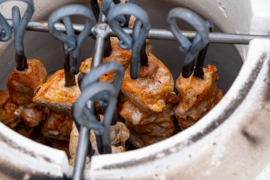 Skewers in the tandoor. Cooking kebab of meat in a tandoor